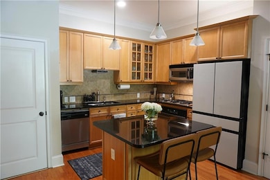 Kitchen featuring sink, a breakfast bar area, hang