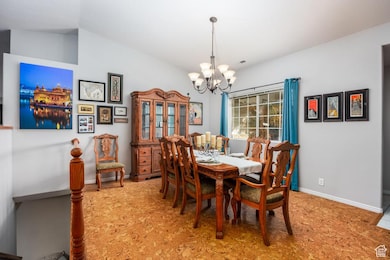 Dining area with a chandelier and vaulted ceiling