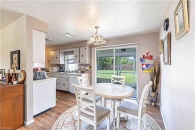Dining area featuring wood finished floors and a chandelier