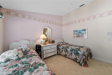 Bedroom featuring vaulted ceiling and light carpet