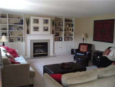 Family Room. Huge family room with custom bookshelves and cabinets. Beautiful neutral decor and warm fireplace.