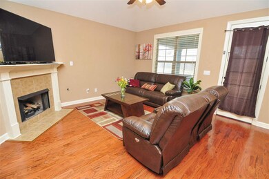 The great room also features gleaming hardwood flo
