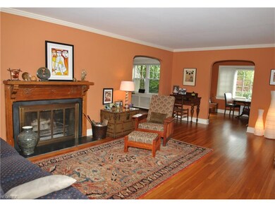 Gleaming hardwood floors grace the living room, di