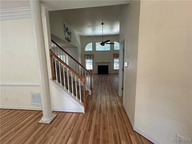 Entryway with ceiling fan, wood finished floors, s