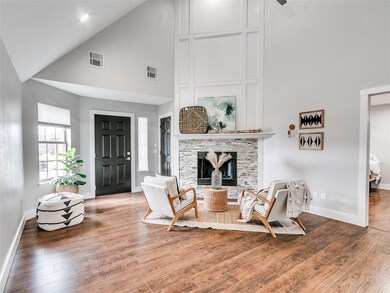 Living room featuring high vaulted ceiling, wood f