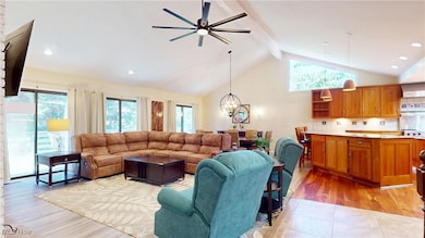 Ceiling fan with light for year round comfort, three sets of glass sliding doors flood the room with natural light and provide access to the expansive deck.
