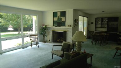 The living room is bright and open with a full wal