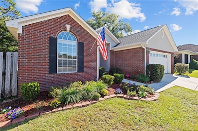 View of front facade with brick siding, an attached garage, and driveway