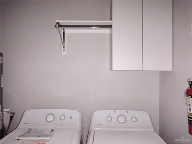 Laundry room with cabinets and washer and dryer