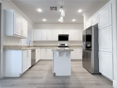 Kitchen featuring visible vents, light wood-style
