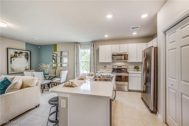 Kitchen with a kitchen island with sink, a kitchen