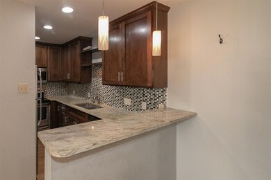 Kitchen with a sink, decorative backsplash, a pen