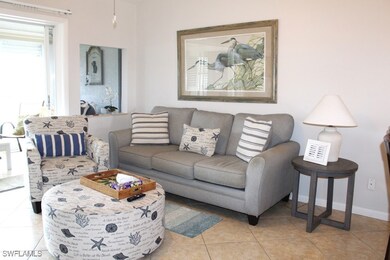 Living room with light tile patterned floors and baseboards