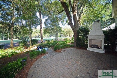 Beautiful paver patio with a small pond and golf c
