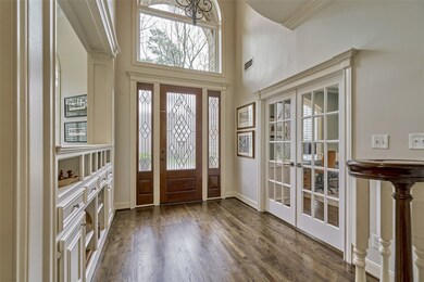 Two story entry with floor to ceiling windows and awesome built-ins!