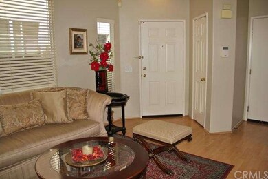Welcoming entry with wood style flooring and a coa