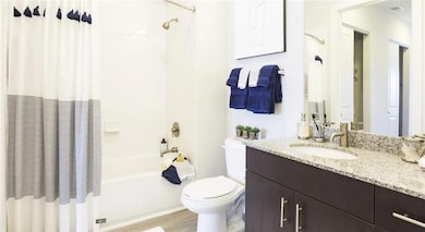 Full bathroom with shower / bath combo, toilet, va