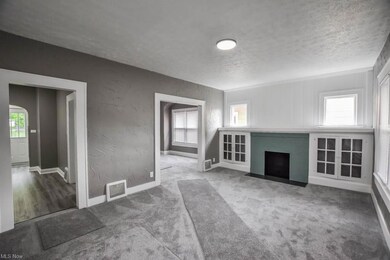 Carpeted living room featuring a textured ceiling