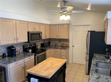 Kitchen featuring light brown cabinetry, stainless