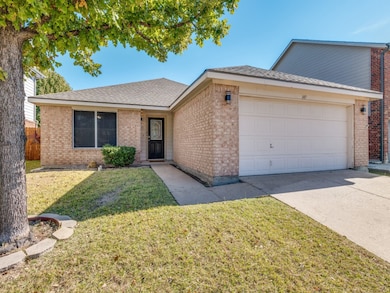 Ranch-style house with roof with shingles, brick siding, driveway, and an attached garage