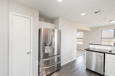 Kitchen with stainless steel appliances, white cab