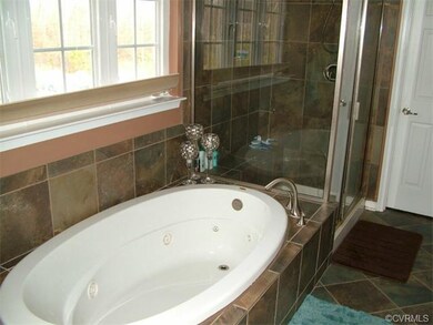 master bath has jetted soaking tub and separate sh