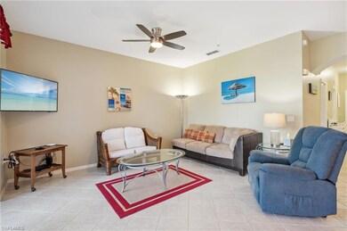 Tiled living room featuring ceiling fan