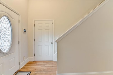 Foyer featuring baseboards and light wood finished floors