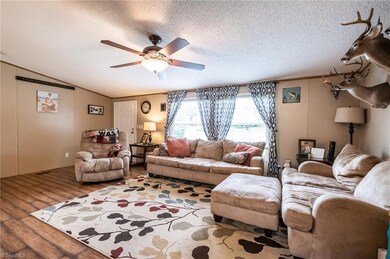 Family room with new flooring and door leading to front deck and yard.