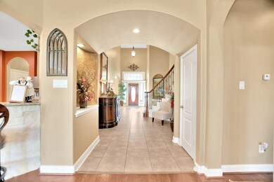 A view from the living area into the front foyer (half bath to the right in Alcove)