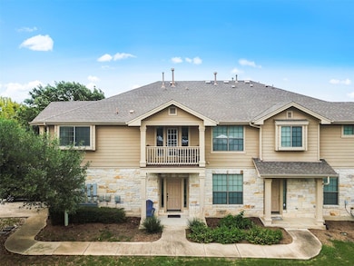 View of property with a shingled roof, a balcony,