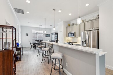 Kitchen with pendant lighting, gray cabinetry, sta