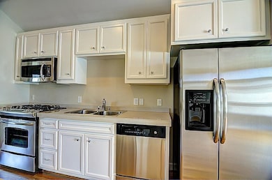 Modern kitchen with stainless steel appliances, in