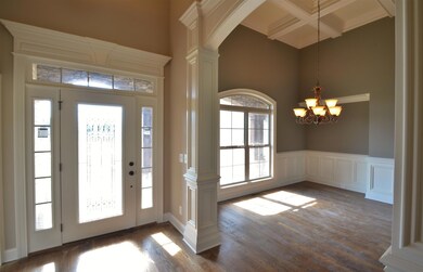 Entry Foyer With Extensive Custom Trim Work Open To Formal Dining