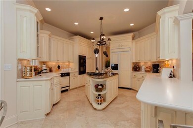 The kitchen is spacious, bright and airy. It features French doors that lead to the back covered patio and is open to the den. This house is wonderful for entertainment!