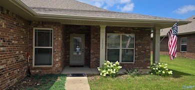 Tucked under a nice cover, you can enjoy this front porch and visit with the neighbors! Easy care landscaping!
