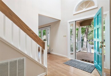 Wood floored entrance foyer with a high ceiling