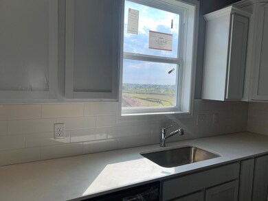 Open and naturally bright, the home's kitchen space is highly desirable and features a Quartz island serving as the perfect centerpiece for entertaining! Model home.