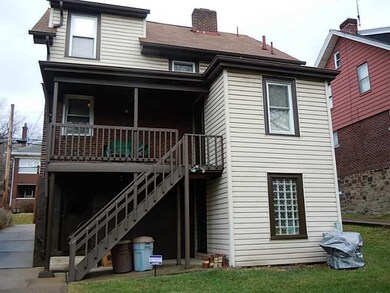 Exterior Back. Rear covered deck and walk out base