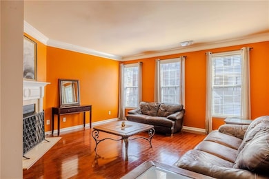 Living area with hardwood / wood-style floors, bas