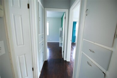 Corridor with dark hardwood / wood-style flooring