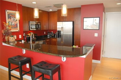Kitchen has eat-in counter, granite counters, stai
