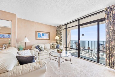Carpeted living room with a textured ceiling, a wa