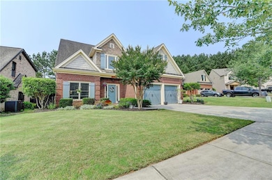 Craftsman-style house featuring concrete driveway, a front yard, brick siding, and central AC