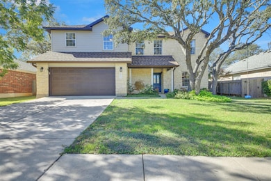 Traditional home with stone siding, roof with shingles, driveway, and a porch