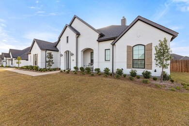French country style house featuring a front lawn,