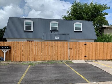 View of front of home with metal roof and uncover