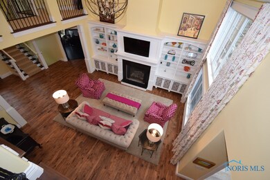 Great room with built-ins, gorgeous windows open t