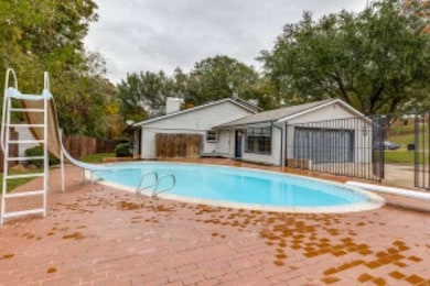 View of pool with a water slide and a diving board