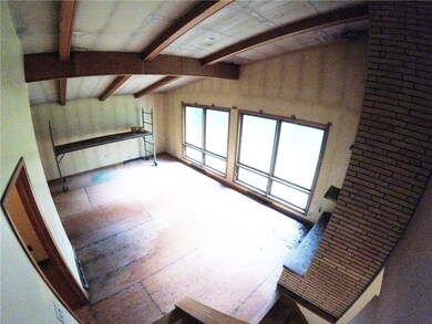 Vaulted ceilings, floor-to-ceiling windows, a wood